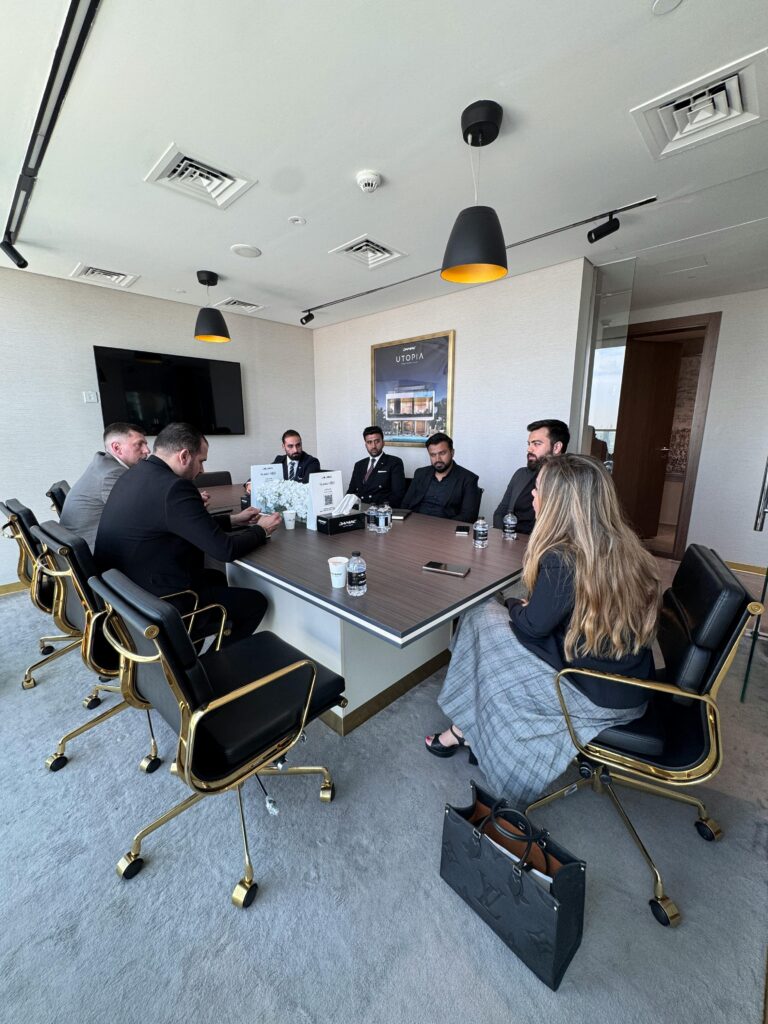 Profissionais em reunião executiva em sala corporativa moderna, representando a colaboração entre times no planejamento de funcionalidades baseadas em histórias de usuário.